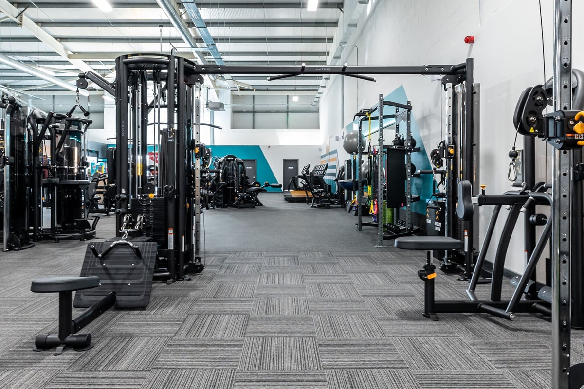 PureGym Great Yarmouth: Weight stacks, cable machines, benches, and rubberized flooring in a spacious gym area.
