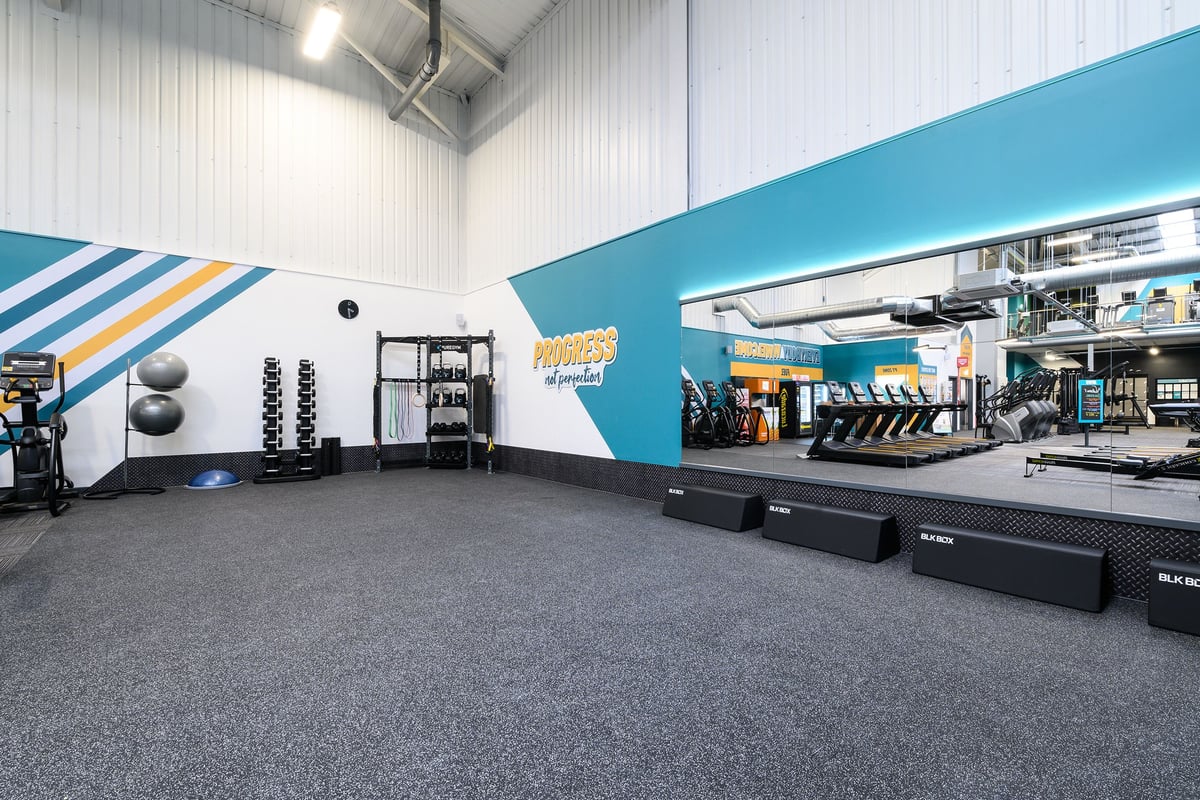 PureGym South Ruislip: Weight racks, free weights, resistance machines, rubberised flooring in a bright gym studio.