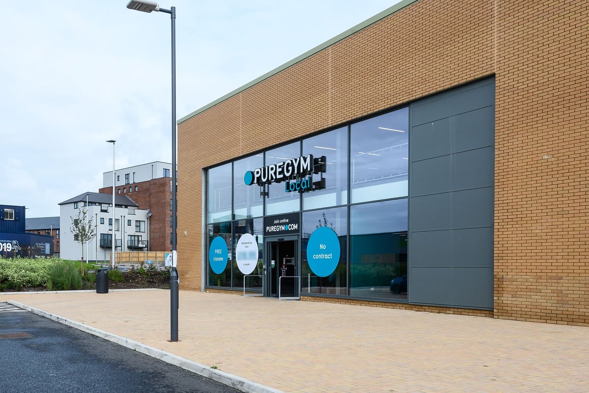 PureGym Barnstaple: Exterior of gym with glass frontage displaying branding and equipment visible inside.