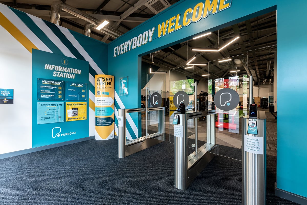 PureGym Ballymena: Entrance area with turnstiles, information station, and signage welcoming visitors.