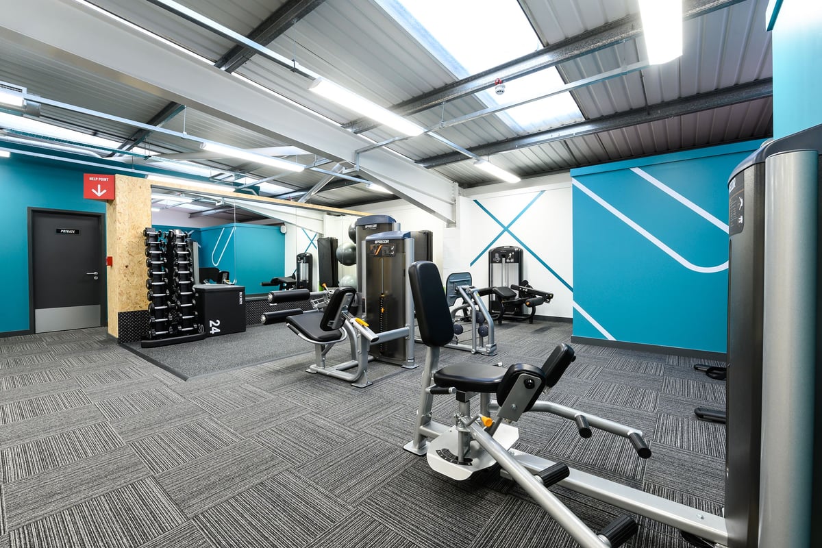 PureGym Rayleigh: Weight machines, resistance bands, exercise balls, rubberized flooring in a gym studio.