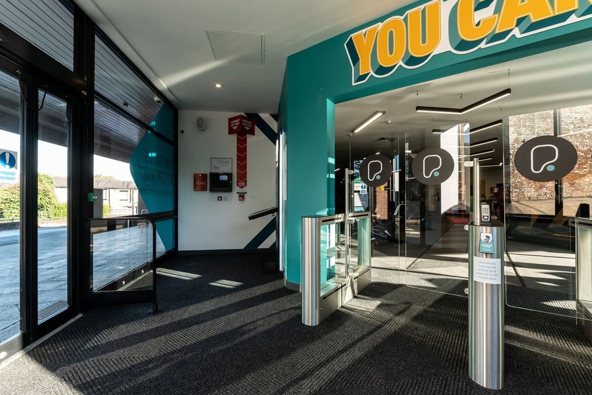 PureGym Tyldesley: Gym entrance with turnstiles, "YOU CAN" signage, and teal branding.