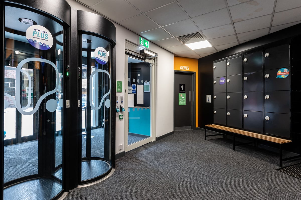 PureGym London Camberwell New Road: Entry area with turnstiles, lockers, and changing room entrance.