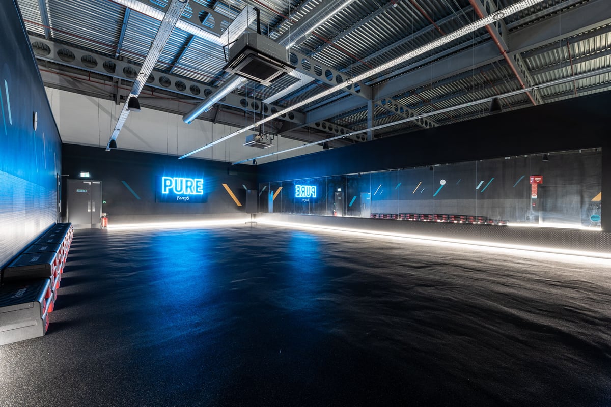 PureGym Peterborough Serpentine Green Shopping Centre: Studio with step platforms opposite a wall of mirrors.