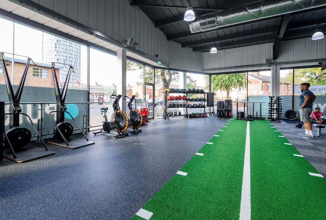 PureGym Leicester Walnut Street: Gym with exercise rigs, free weights, resistance bands, turf area, and rubberized flooring.