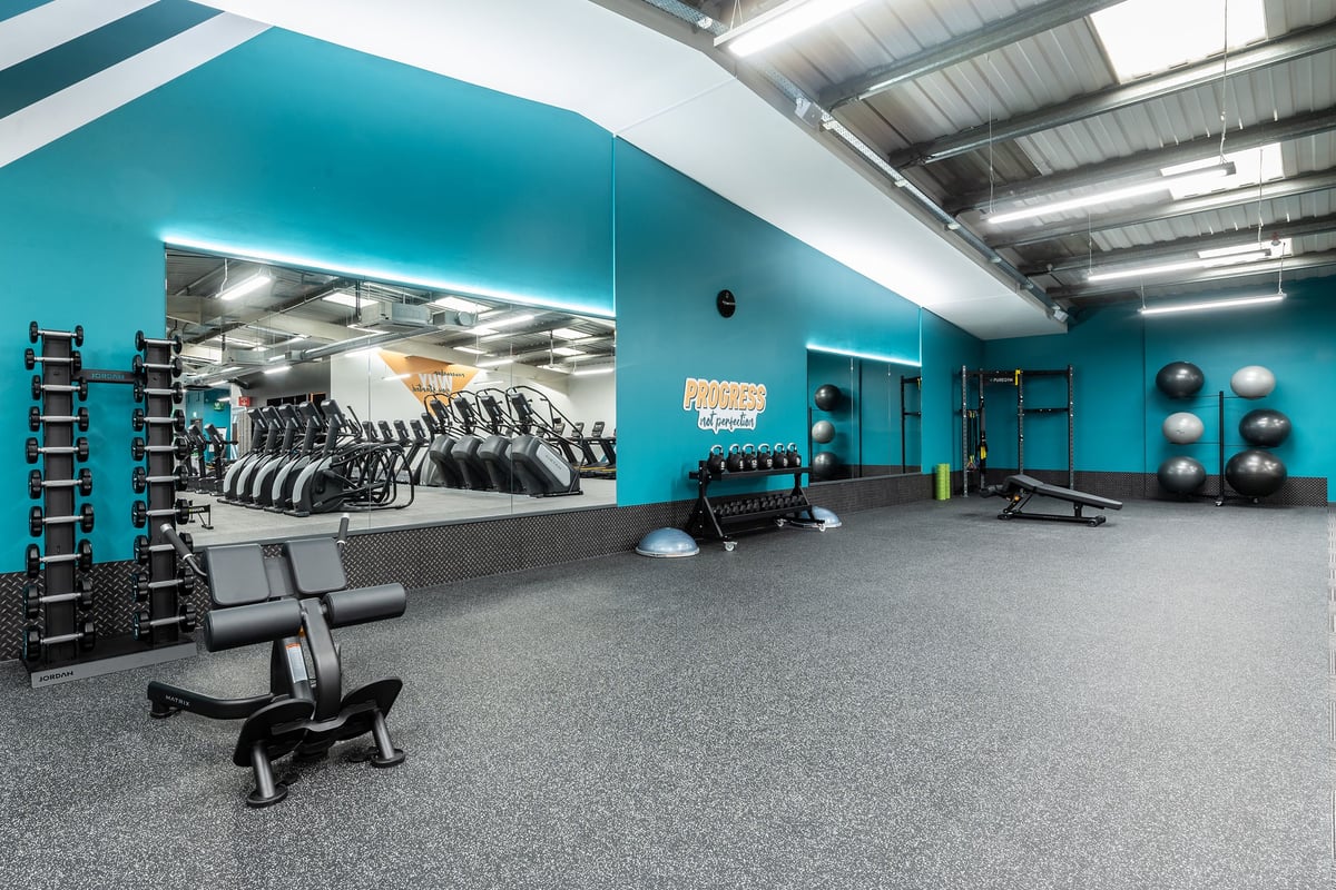 PureGym Cardiff Western Avenue: Weight racks, dumbbells, kettlebells, medicine balls, and mirrored walls.