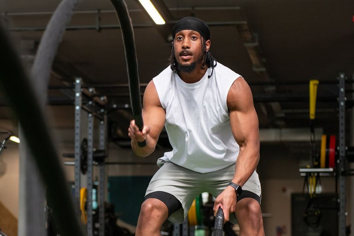 Man using battle ropes in gym setting