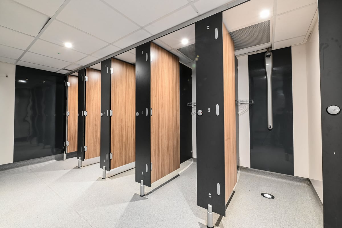 PureGym London Piccadilly: Rows of lockers with wooden and black finishes in a changing room setting.
