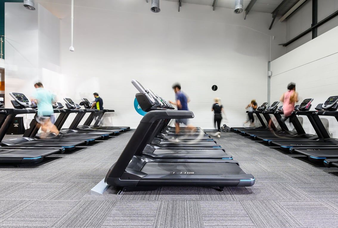 PureGym Bristol Abbey Wood Retail Park: Rows of treadmills lined up in a bright fitness studio.