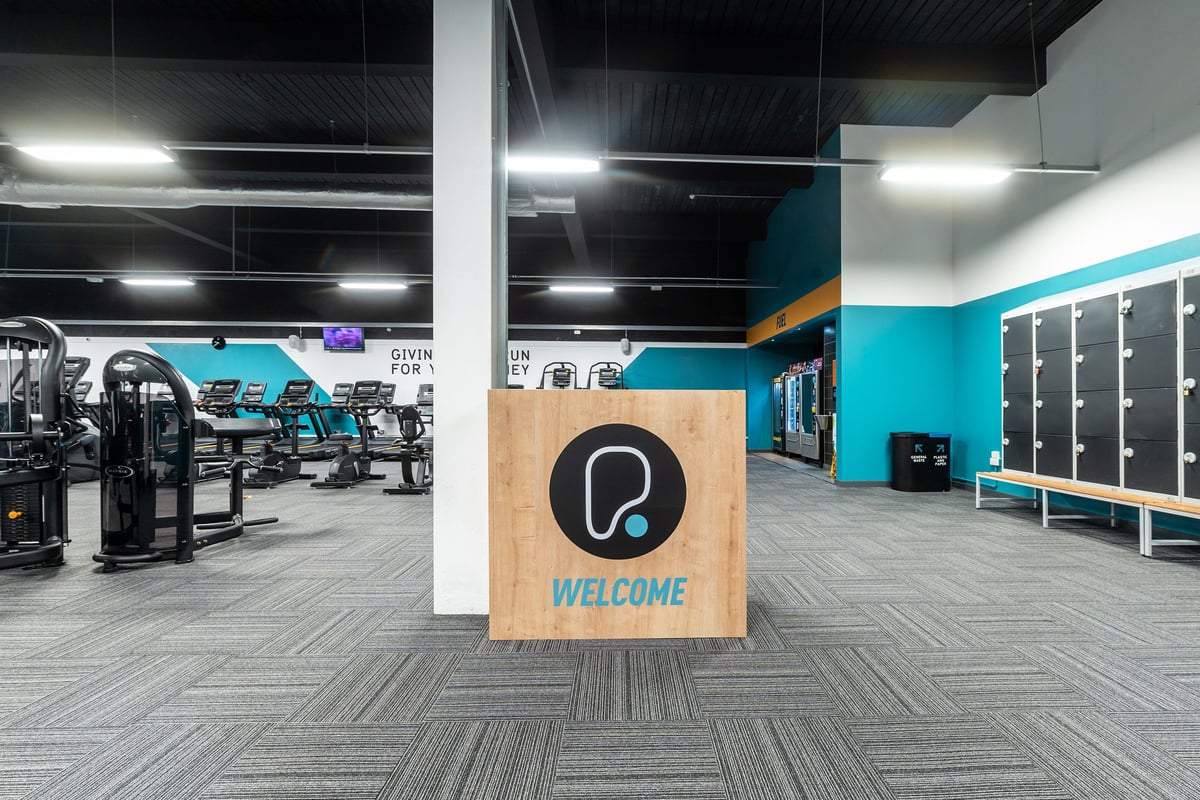 PureGym Bradford Thornbury: Weight machines, free weights, benches, and rubberized flooring in a fitness centre interior.