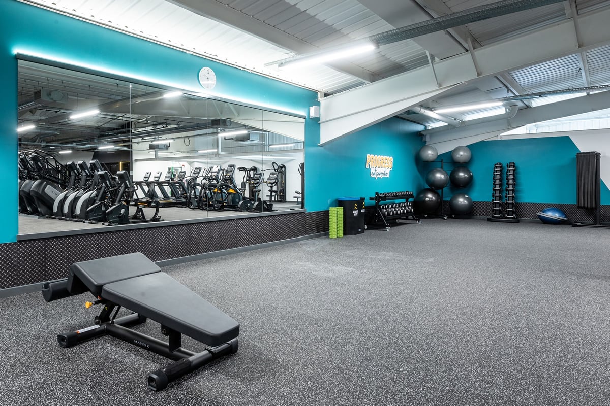 PureGym Cheshunt Brookfield Shopping Park: Stationary bikes, bench press stations, free weights, and rubberized floors.