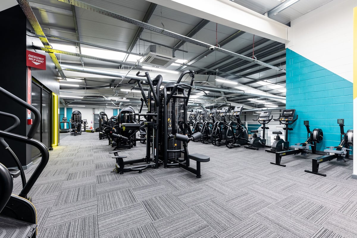 PureGym Sheffield Crystal Peaks: Strength training area with weight racks and benches.