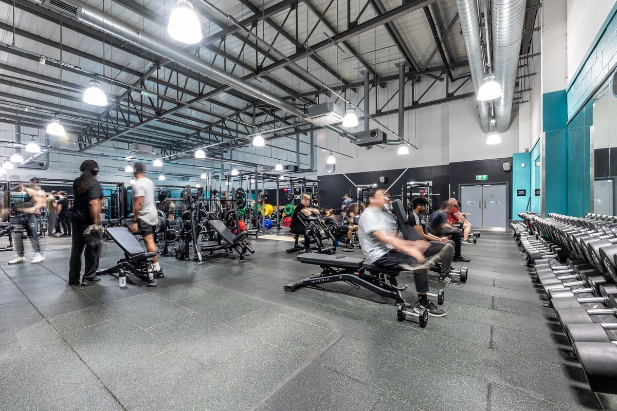 PureGym Wolverhampton Bentley Bridge: Weights, benches, treadmills, and mirrored walls in a spacious gymnasium interior.