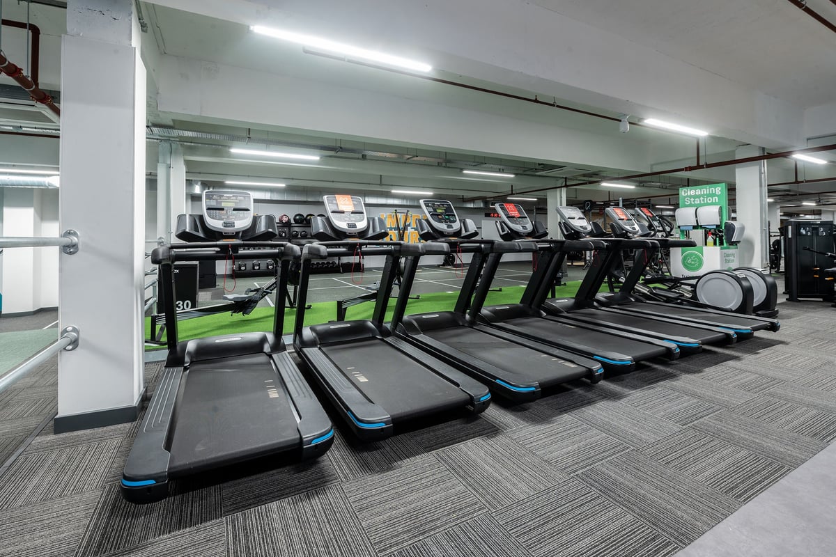PureGym Gravesend: Rows of treadmills in a well-lit gym space with rubberised flooring.