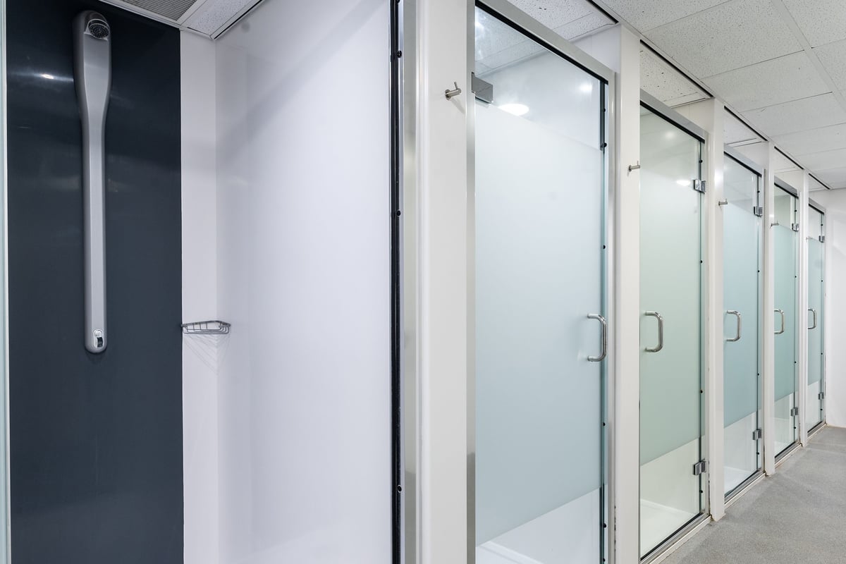 PureGym Bristol Union Gate: Fully enclosed shower stalls with frosted glass doors.