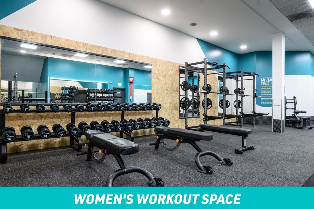 PureGym Staines Women's Workout Space: rows of dumbbells and benches with large mirror