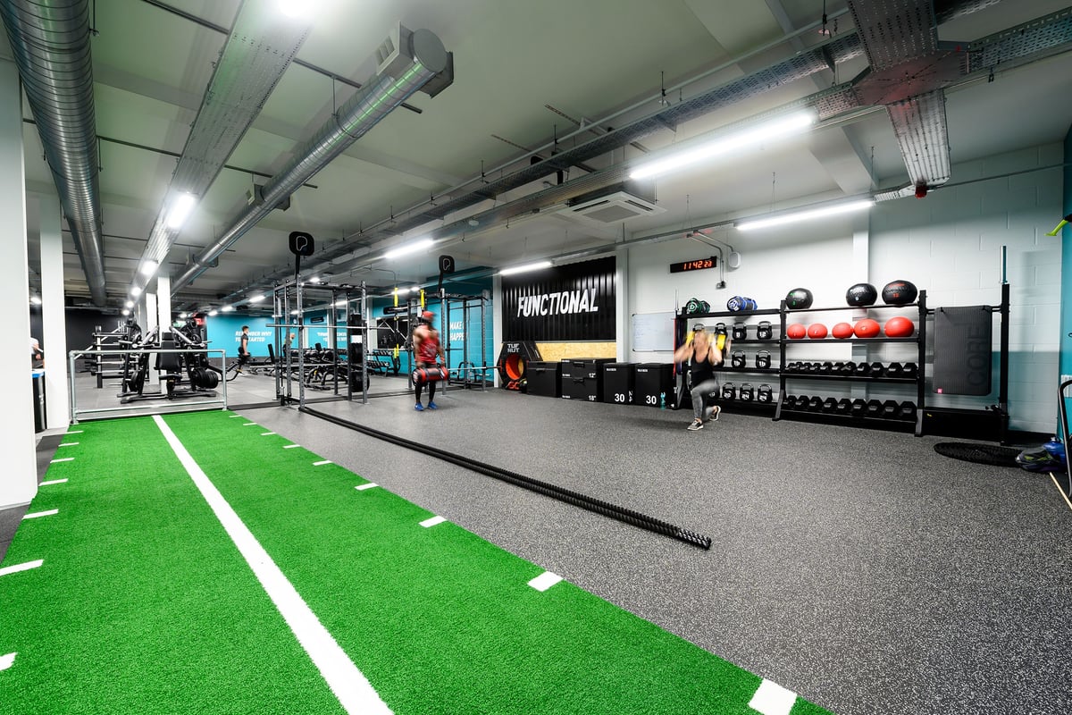 PureGym Salisbury: Functional training area, green turf, free weights, weight racks, and exercise equipment.