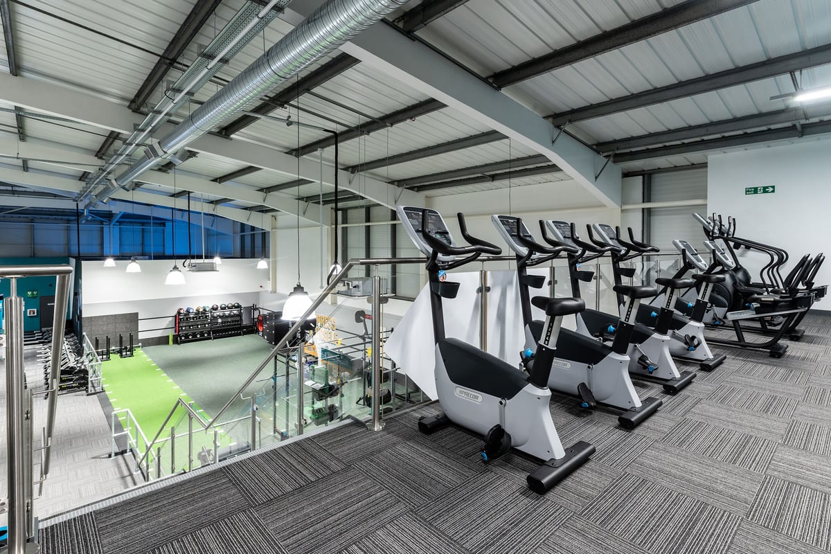 PureGym Torquay Bridge Retail Park: Rows of stationary bikes, treadmills, and weight machines in a bright gym interior.