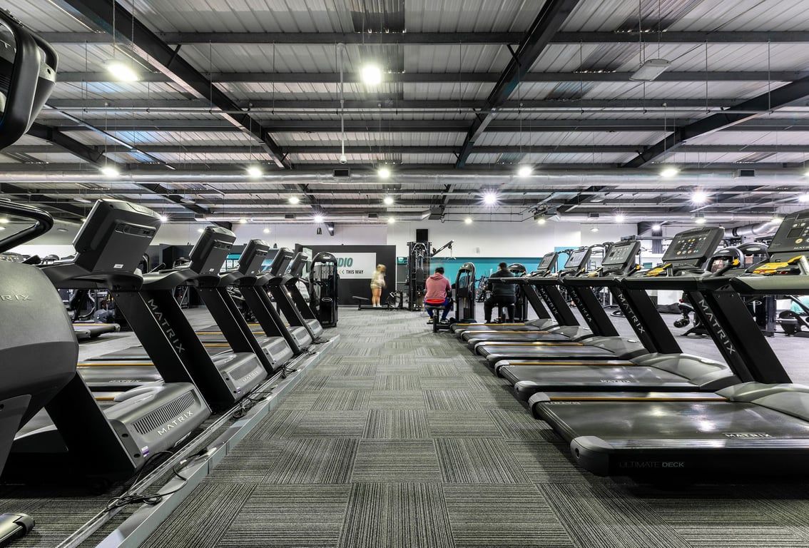 PureGym Lincoln St Marks Centre: Rows of treadmills inside a well-lit gym space with industrial ceiling.