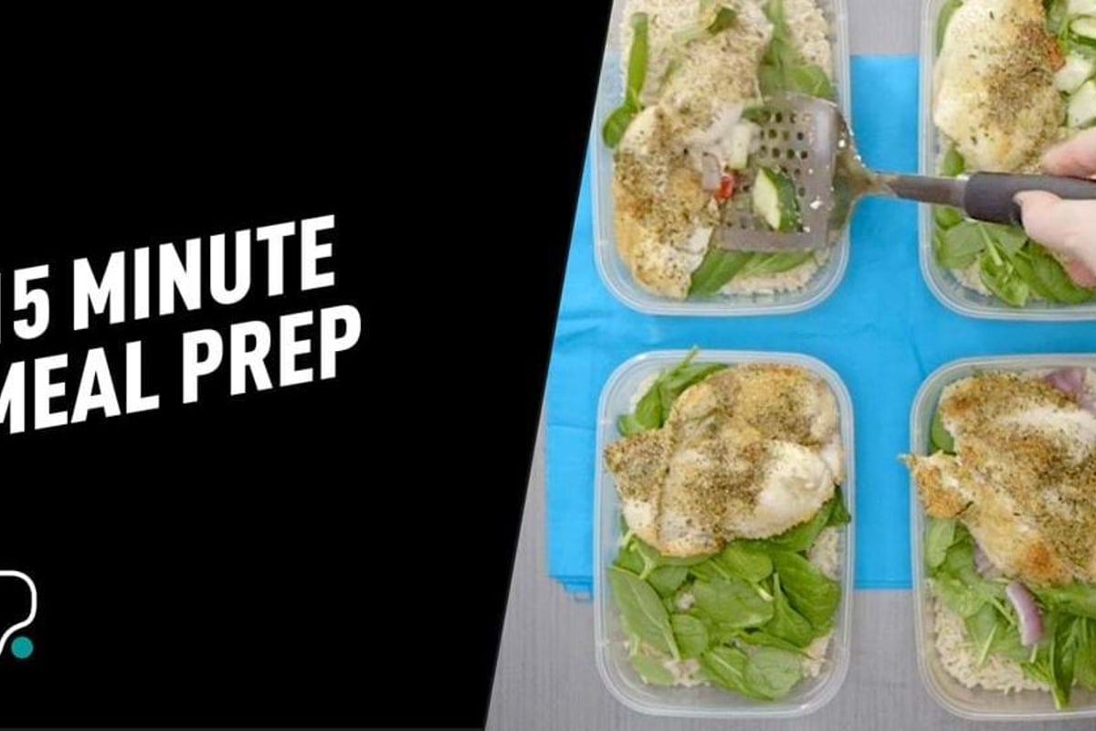 Four meal prep containers with chicken, green vegetables and seasoning on blue mat