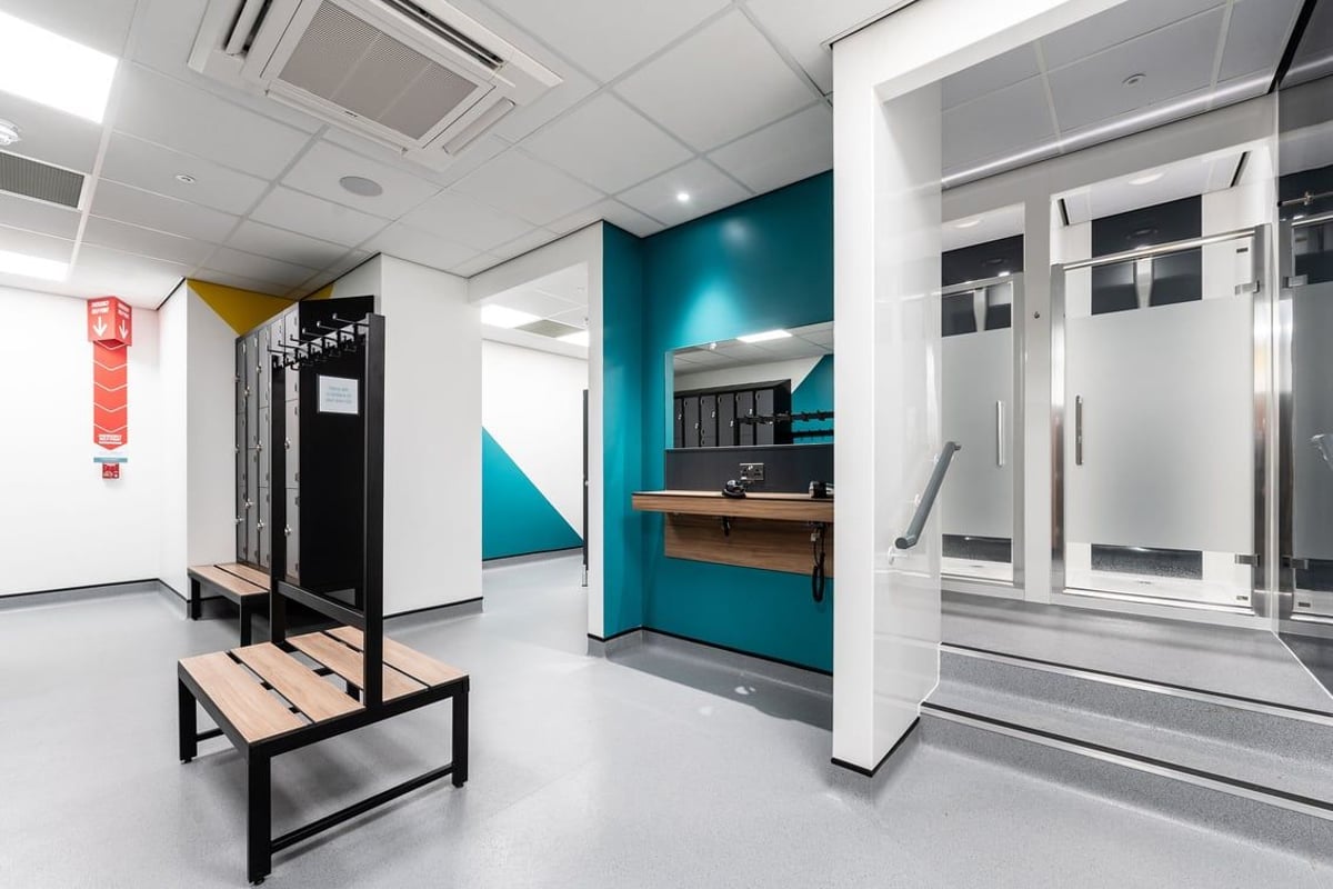 PureGym Derby Meteor Centre: Changing cubicles, benches, lockers in a gym or fitness changing area.