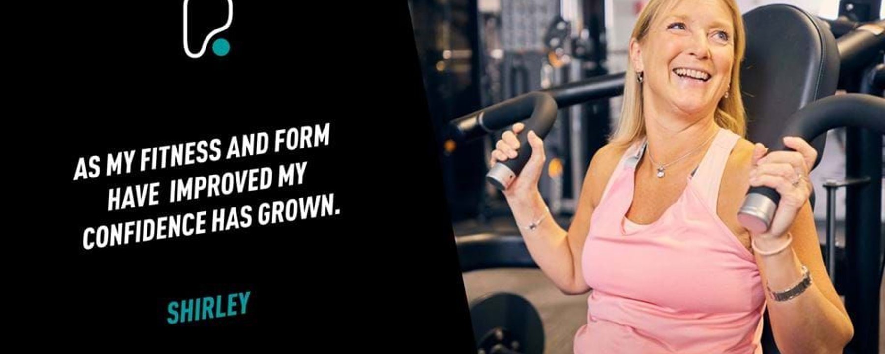 Woman in pink top using gym machine and smiling in fitness centre.