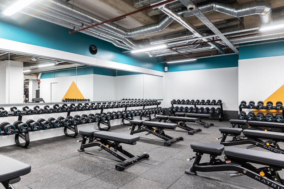 PureGym London Monument: Rows of weight benches, free weights, and resistance machines in a gym studio.