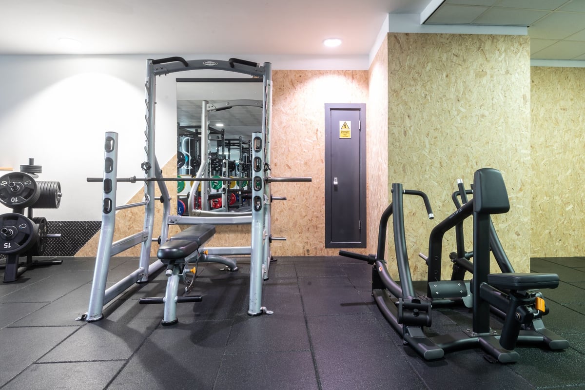 PureGym Edinburgh Exchange Crescent: Gym with weight machines, squat racks, free weights, and rubberized flooring.