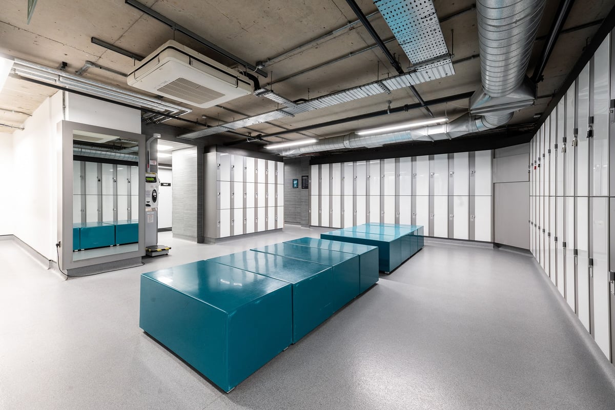PureGym London Aldgate: Pool, blue hydrotherapy vats, ductwork ceilings, lockers lining walls.