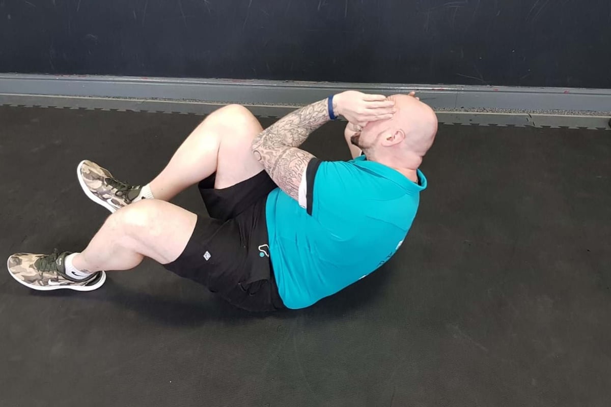 Lazy biker ab exercise end position