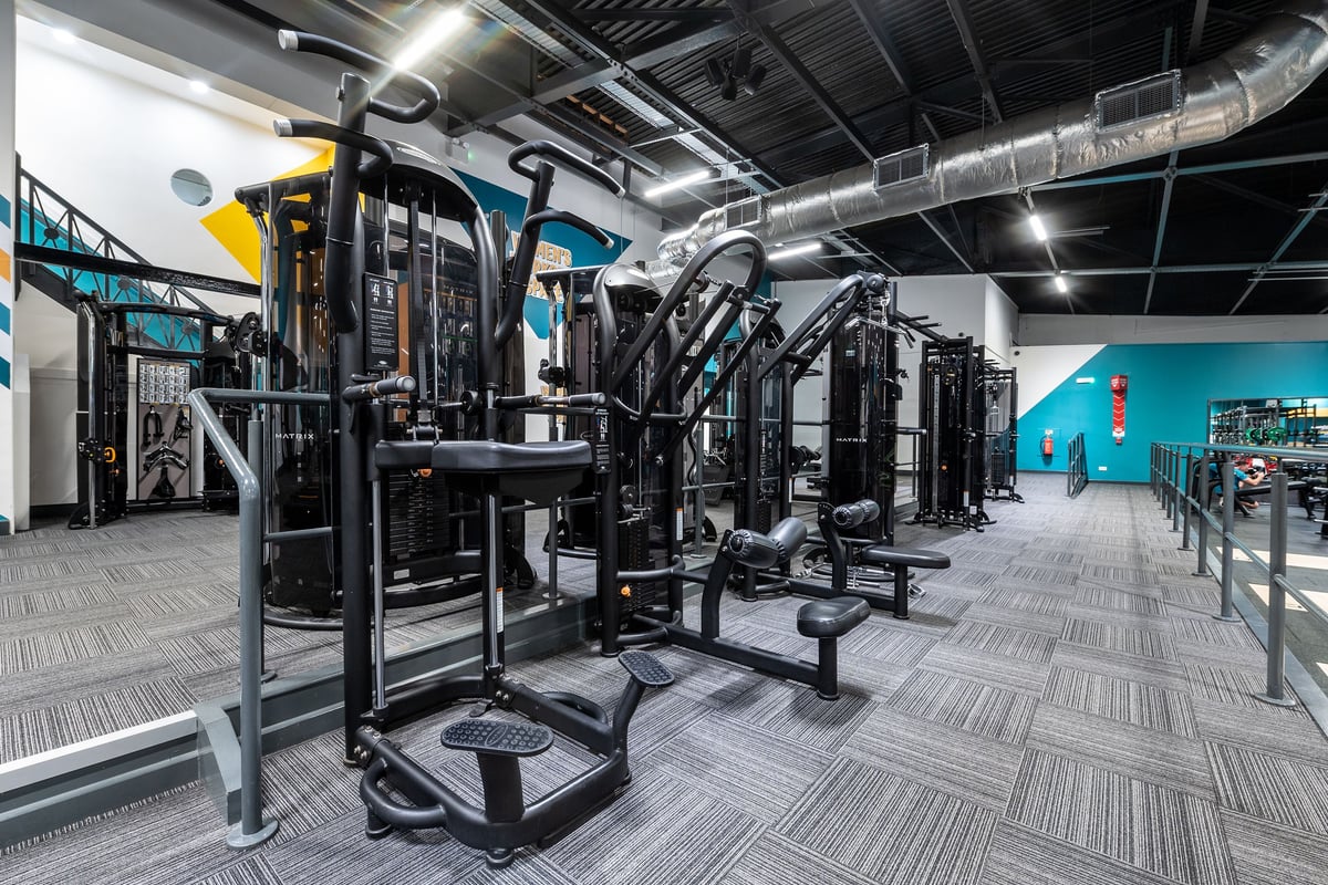 PureGym Southampton Bitterne: Rows of weight machines, cable stations, and weightlifting platforms with rubberized flooring.