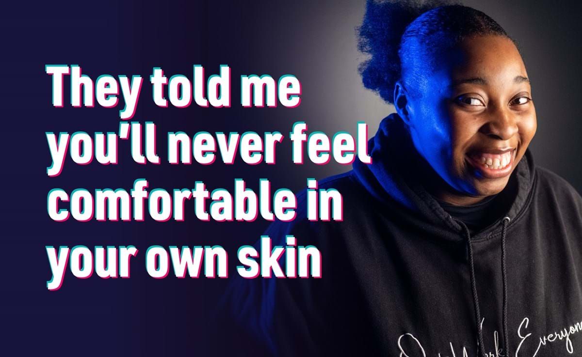 Smiling person in black hoodie with text about feeling comfortable in your own skin