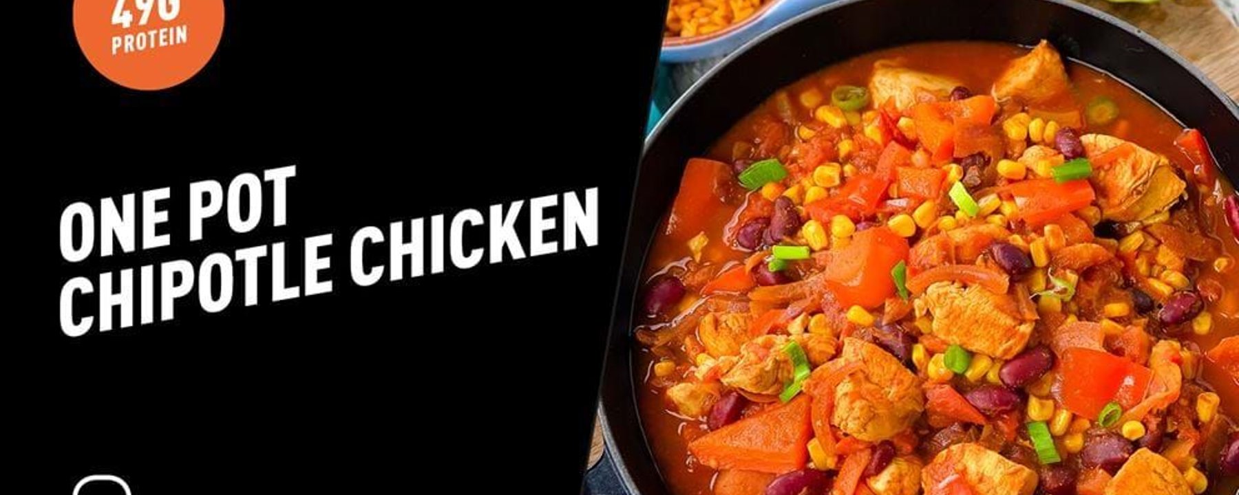 One pot chipotle chicken stew with corn, beans, and red peppers in a black pan