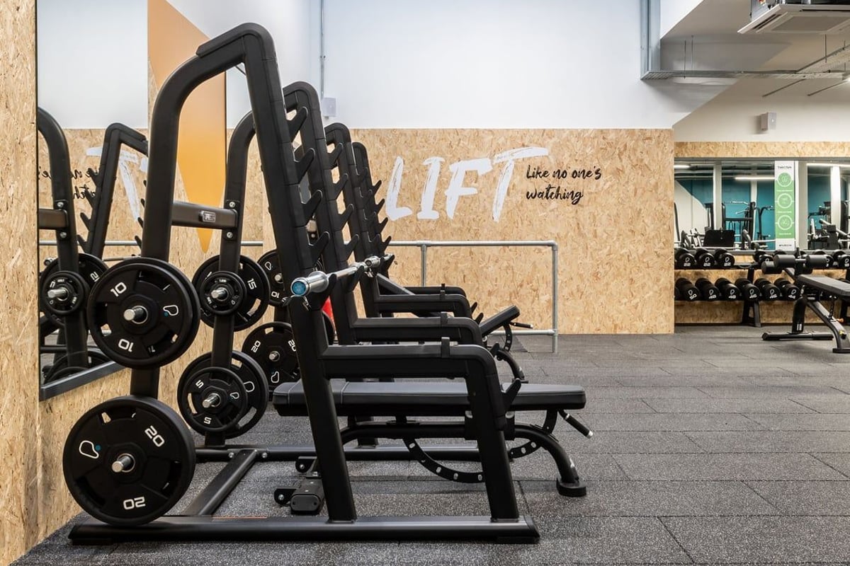 PureGym Inverness Inshes Retail Park: Rows of weighted sleds and resistance machines on rubberized flooring in a gym space.