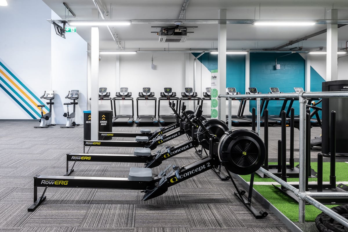 PureGym Inverness Inshes Retail Park: Rows of treadmills, weight racks, free weights, benches on rubberized gym flooring.