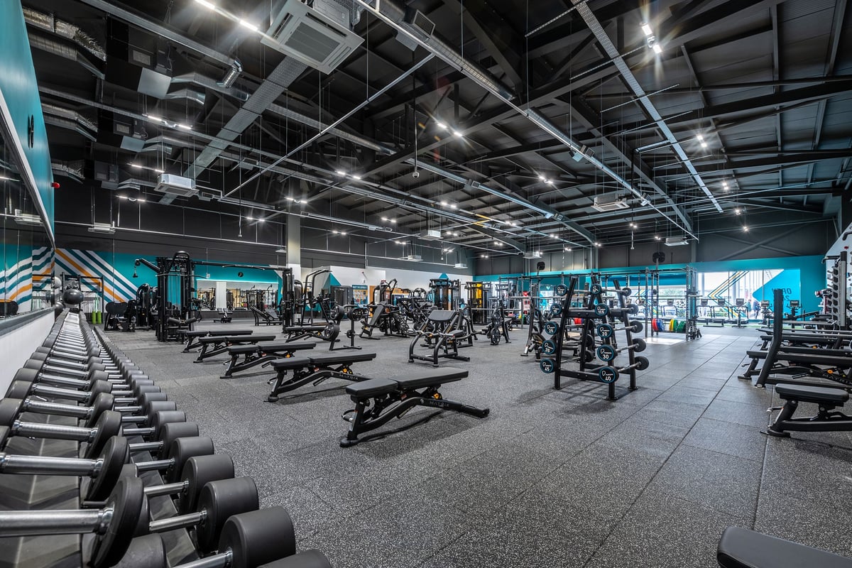 PureGym Walsall Crown Wharf: Rows of weightlifting benches, dumbbell racks, weight plates, and open floor space for functional training.