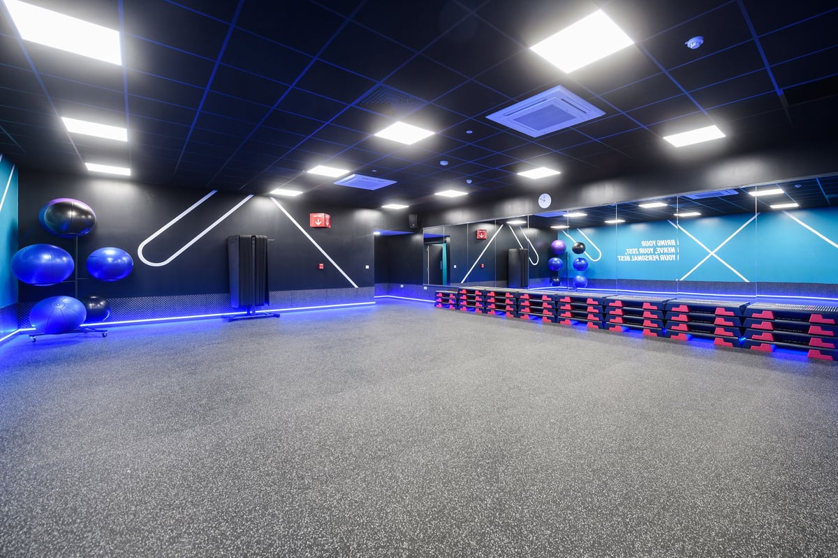 PureGym Southend Fossetts Park: Gym studio with stability balls, weight racks, mirrored walls, and rubberized flooring.