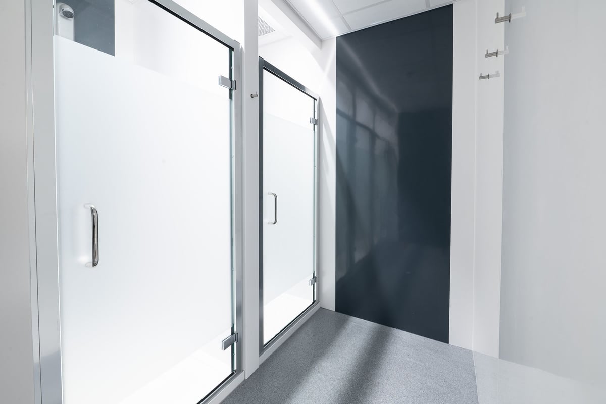 PureGym Dover: Glass doors leading into what appears to be changing rooms or shower facilities.
