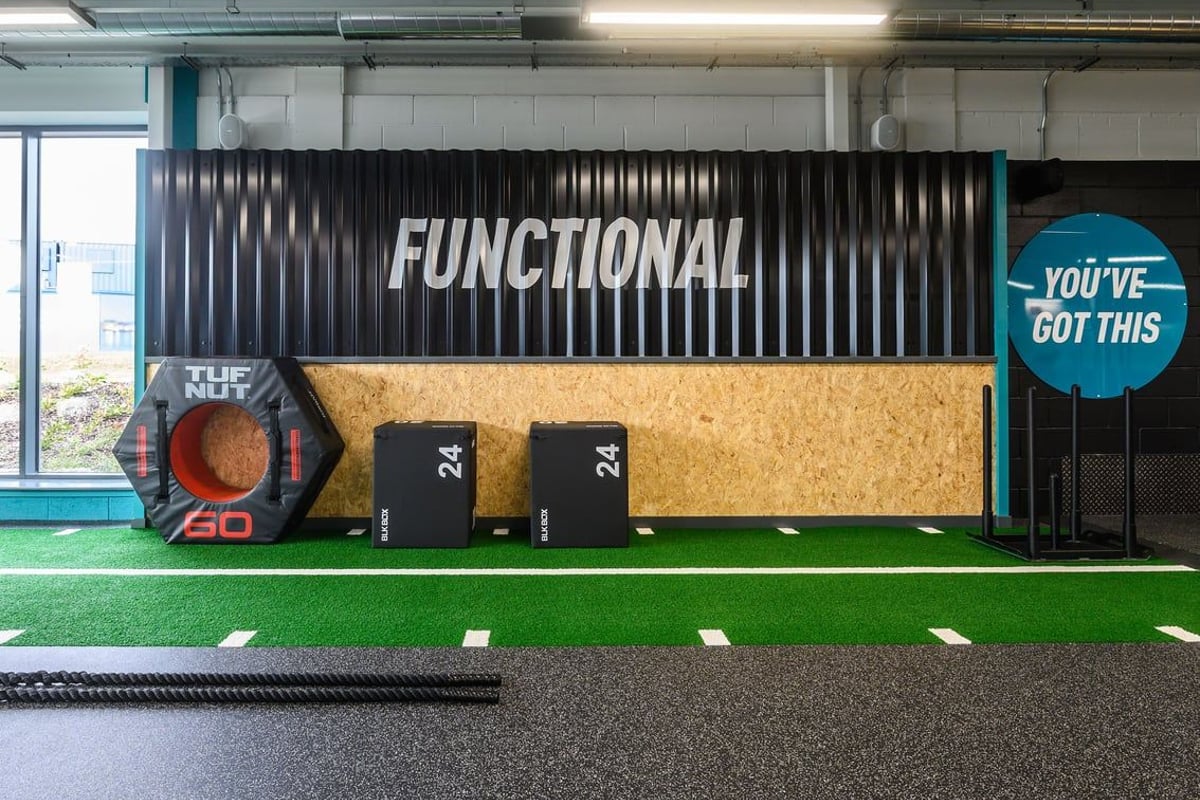 PureGym Barnstaple: Turf area with plyo boxes, medicine balls, functional training rig, and motivational signage.