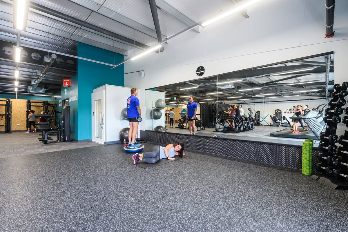 PureGym Barnstaple: Freeweights, benches, resistance machines, and rubberised flooring in a gym studio.