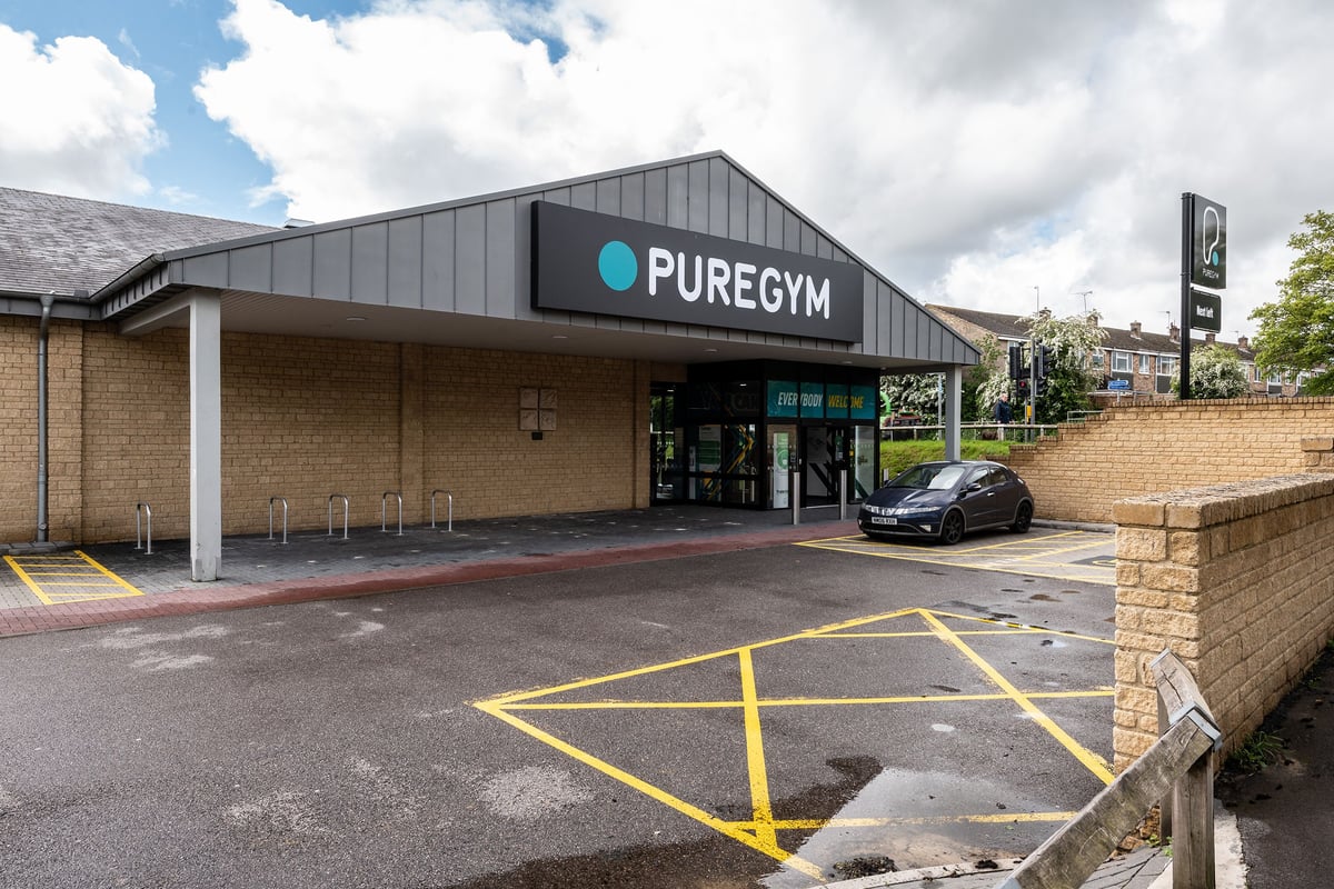 PureGym Witney: The entrance to a Pure Gym facility with parking spaces visible.