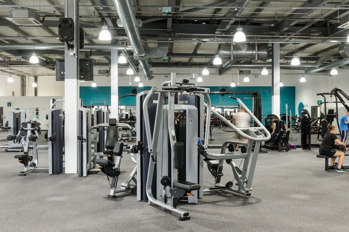 PureGym Worcester: Cable crossover machines, resistance equipment, weight stacks, and padded benches in a gym setting.
