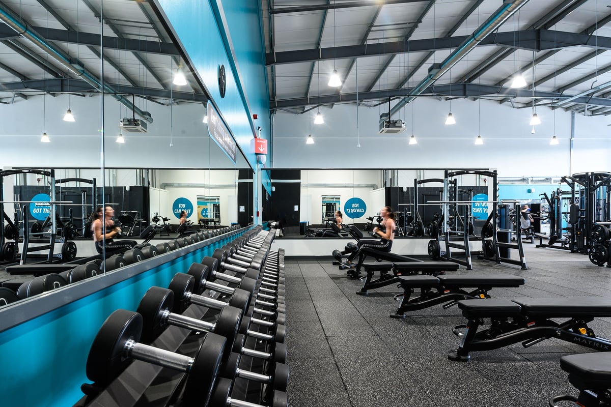 PureGym Maldon Blackwater Retail Park: Rows of weight benches, barbells, weight plates and resistance machines.
