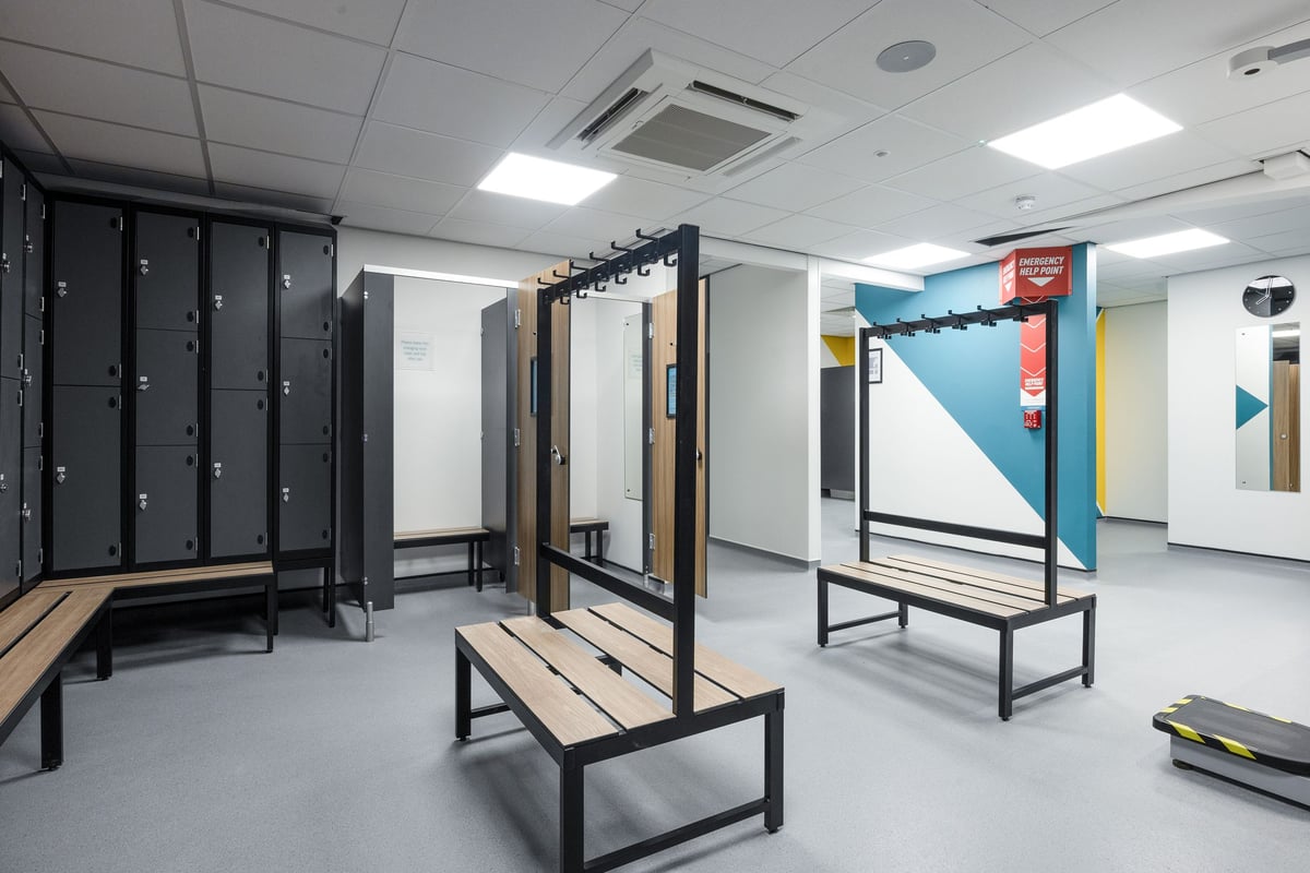 PureGym Falkirk: Locker rows, benches, mirrors, and open plan layout - typical of a gym changing area.
