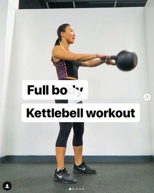 Woman swinging a kettlebell in a gym with white walls and grey floor