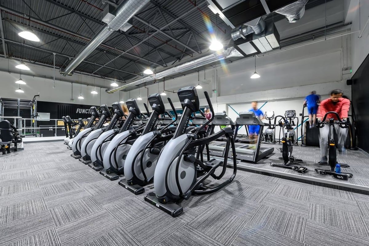 PureGym Northampton Weston Favell: Rows of elliptical cross-trainers and stationary bikes in a gym setting.