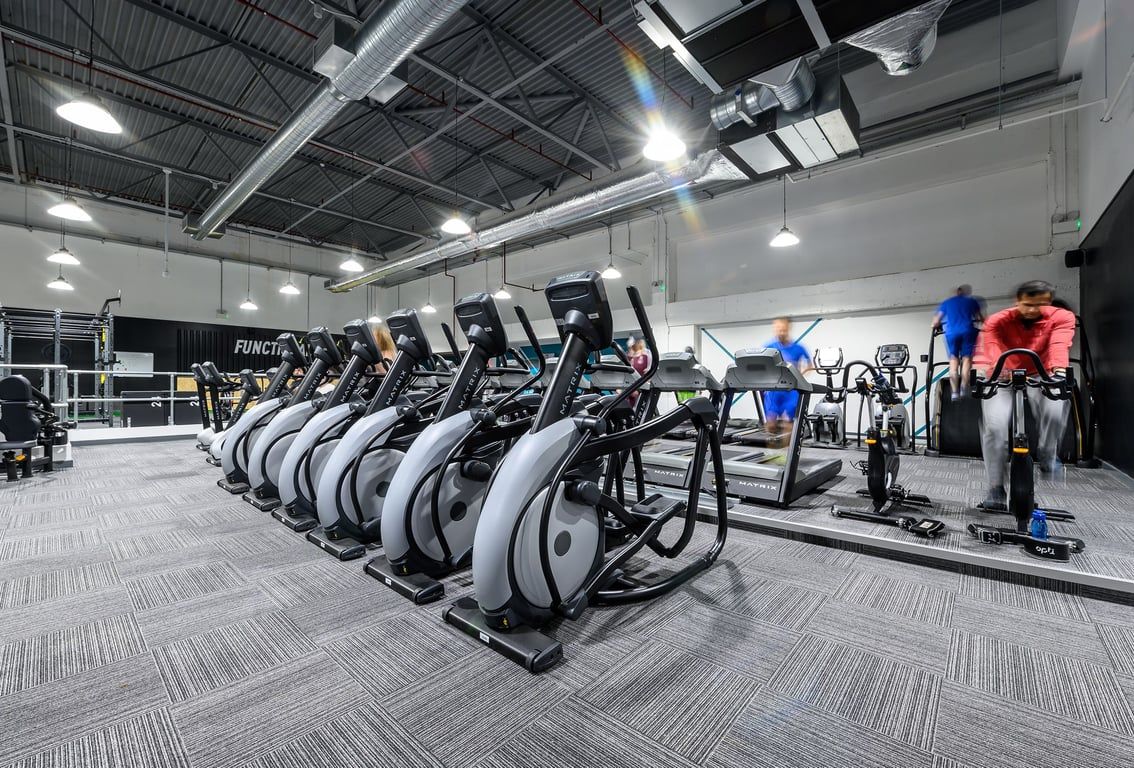 PureGym Northampton Weston Favell: Rows of elliptical cross-trainers and stationary bikes in a gym setting.