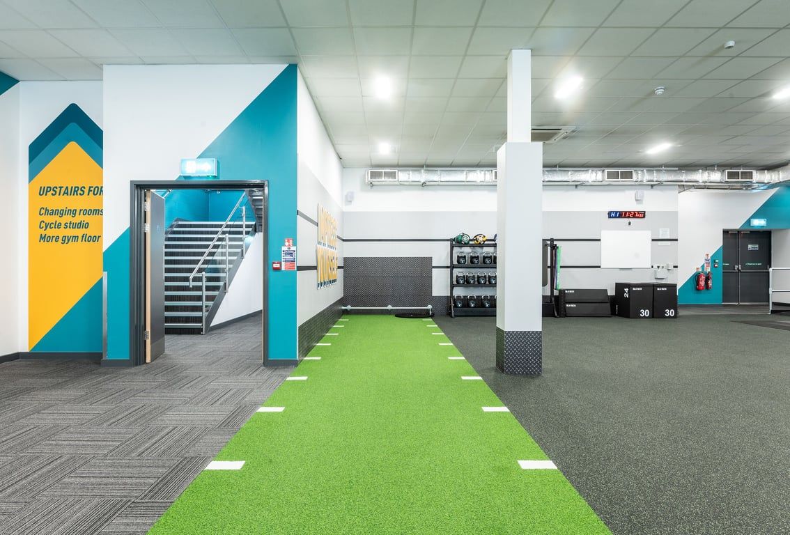 PureGym Coventry Warwickshire Shopping Park: Functional training area with kettlebells, turf, and ploymetric jump boxes.