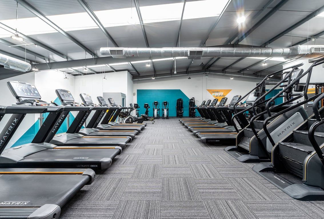 PureGym Coventry Warwickshire Shopping Park: Rows of treadmills, cycle machines and stair climbers in a modern gym facility.