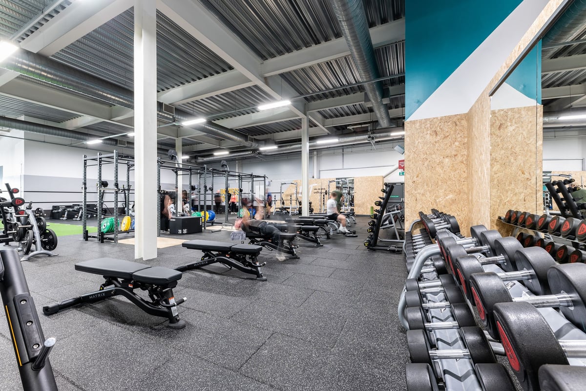 PureGym Hednesford Cannock: Weights racks, benches, rubberized floors, and workout equipment in a modern gym facility.